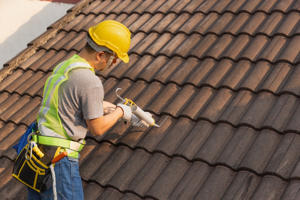 Worker,man,using,silicone,sealant,adhesive,to,fix,crack,of