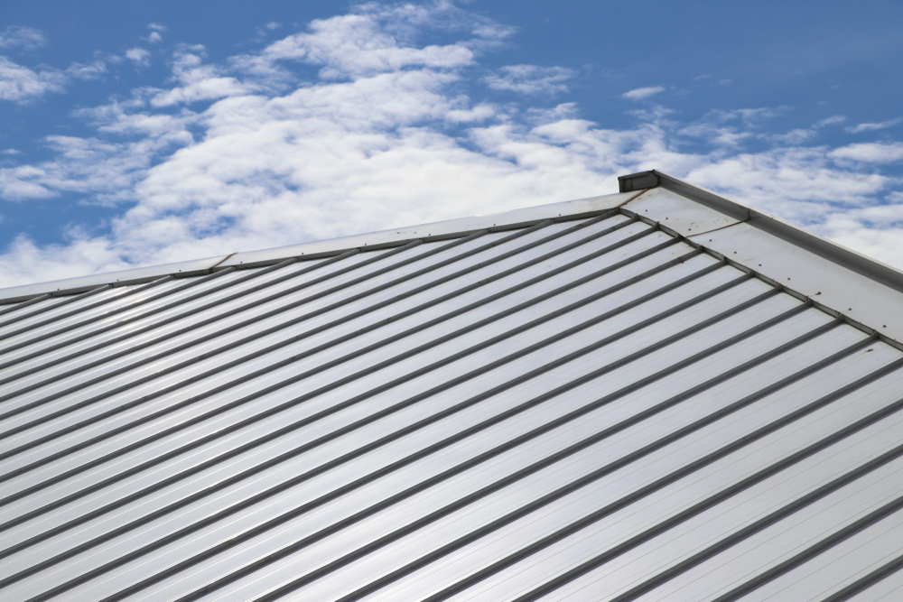 Metal,sheet,roof,and,slope,with,clouds,and,blue,sky